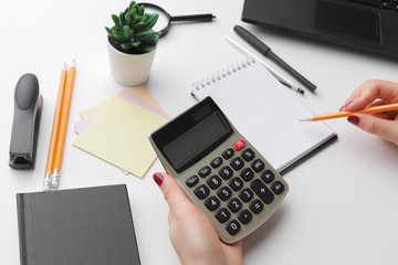 Business woman working with financial data hand using calculator