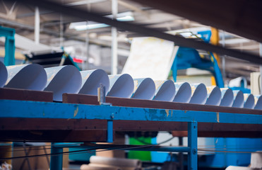 A beautiful smooth clean paper roll machine creating a continuous sheet of white freshly made paper...