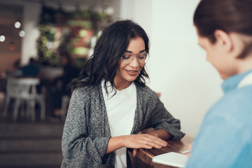 Pretty lady putting her hand on the bar counter while making her order