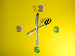 Knife and fork with time digits. Mean time to eat