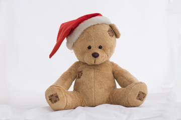 Teddy Bear with Christmas Hat sitting on white background