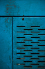 A blue smooth hard industrial machinery metal texture background, showing signs of scratches,...