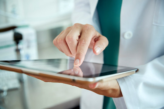 Doctor touching a tablet