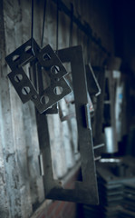 Industrial sheet metal steel products on a production line in an industrial factory setting, with atmospheric lighting. Being prepared for paint treatment. Industrial sheet metal.
