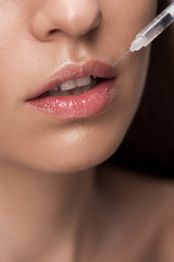 Naklejka premium close up of woman making beauty injection into lips