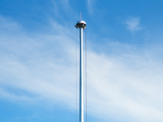 Repair the pillars spotlights with blue sky view. Sport light pole drop with sling for repairing and maintenance on the ground. - selective focus.