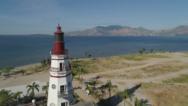 Coastline with beach and lighthouse, mountains. Aerial view: Coast sea with hotels, resorts, Subic Bay, Philippines, Luzon