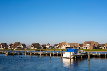 Fototapeta na wymiar Holiday homes on the waterfront in Friesland, the Netherlands.