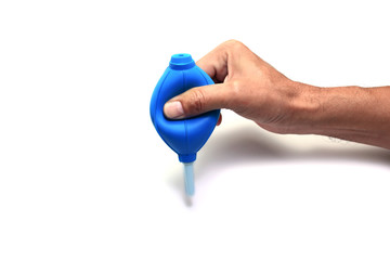 the right hand squeeze the blue rubber blower on white background isolated