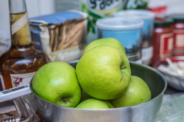 Green apples in a bowl on the kitchen table