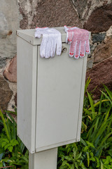 two gloves stand on the electricity cabinet