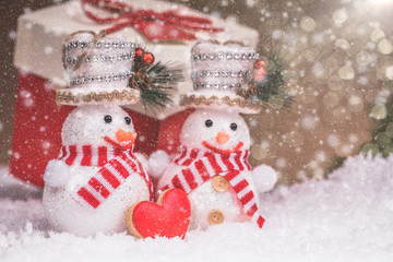 Snowman couple with heart and Christmas decorations