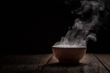 Hot soup is placed on the black backing table.