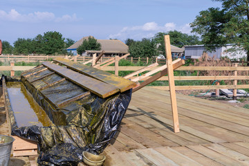 Wooden bath for impregnation of building boards with antiseptic protective. Covers antiseptic boards.