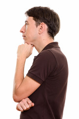 Profile view of man thinking with hand on chin