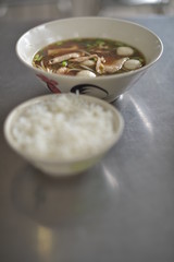 Pork balls in brown soup served with a stream jasmine rice.