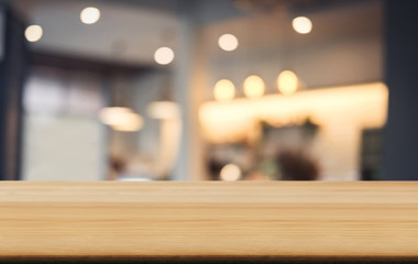 Selective Empty wooden table and blurred background of abstract in front of coffee shop or restaurant for display of product or for montage