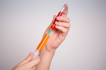 A doctor with a syringe makes an injection.
