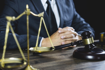 Counselor or Male lawyer working on courtroom sitting at the table. Legal law, Judge gavel with Justice lawyers advice with gavel and Scales of justice