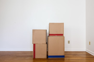 Paper`s moving  boxes on wooden floor in empty room