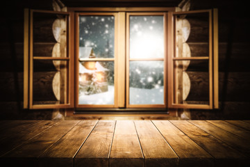 wooden table of free space for your decoration and wooden window with winter landscape 