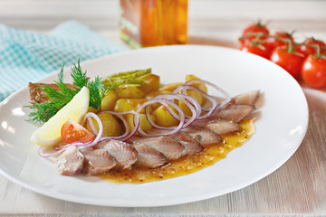 A dish of fish on a stew with vegetables