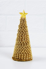 Diy golden Christmas tree from beads garland. Guide on the photo how to make a decorative Christmas tree from cardboard, stars, hot glue and beads with your own hands. Handmade Christmas decor.