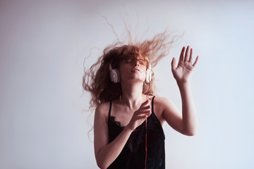 Portrait of woman dj enjoying music on headphones - obrazy, fototapety, plakaty
