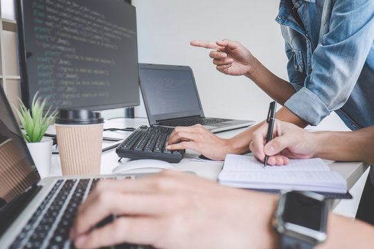 Programmers cooperating at Developing programming and website working in a software develop company office, writing codes and typing data code