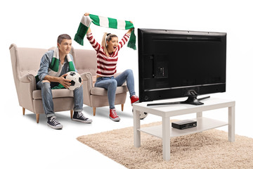 Male and female soccer fans watching a game