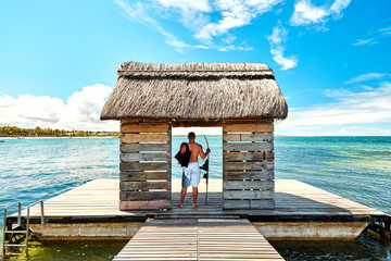 Jetty with man silhouette on pontoon in Mauritius Island - obrazy, fototapety, plakaty