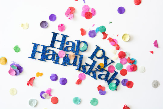 Happy Hanukkah and confetti background

