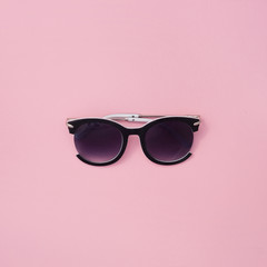 Sunglasses for women on a pink background. Square summer texture.