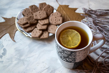 A cup of tea with lemon and cakes. Hygge flat lay.