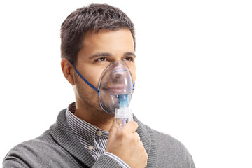 Young man wearing an inhalation mask