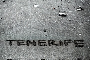 tenerife text title on volcanic beach black sand