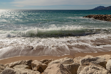 wave crashing into sand