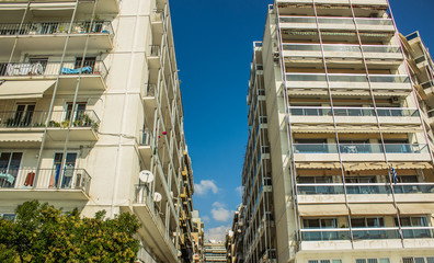 south European Mediterranean city street urban view with apartment buildings symmetry facade in summer warm clear bright weather time