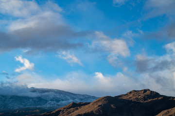 cloudy November sky over Eastern Sierra Nevada hills, mountains, desert valley, California, USA