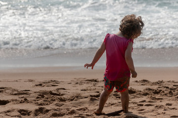 Fototapeta na wymiar The Side Of A Little Girl At The Beach