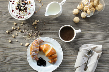 Wooden table with breakfast food on it
