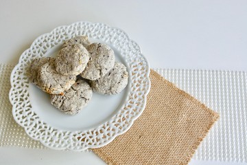 Tasty coconut cookies on the white plate on the white background