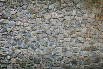 texture old wall made of stones of different sizes close-up