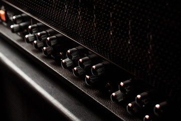A guitar combo amplifier or speaker closeup on black background