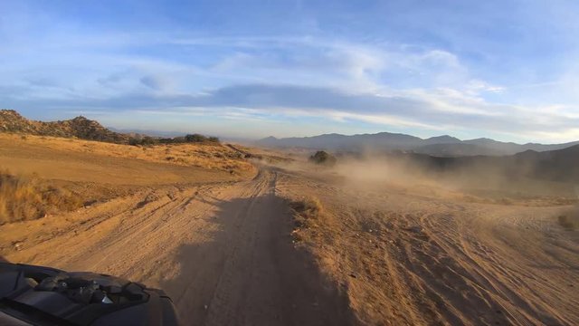 Epic trail running through Mojave Desert at sunset golden hour, Point of View