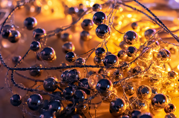 Christmas background from metal balls illuminated by a garland.