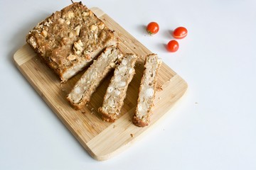 Tasty bread on the white background with red tomatoes