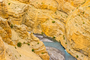 Between the yellow sand rocks flowing blue river