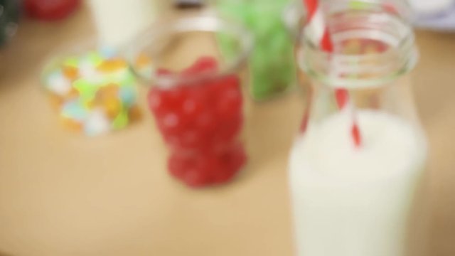 Kids party to decorate small gingerbread houses  with candies.