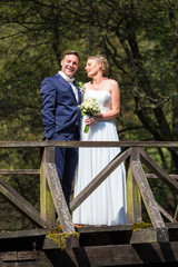 Happy couples together in nature. Wedding and wedding dress. Bouquet of white roses. Love.